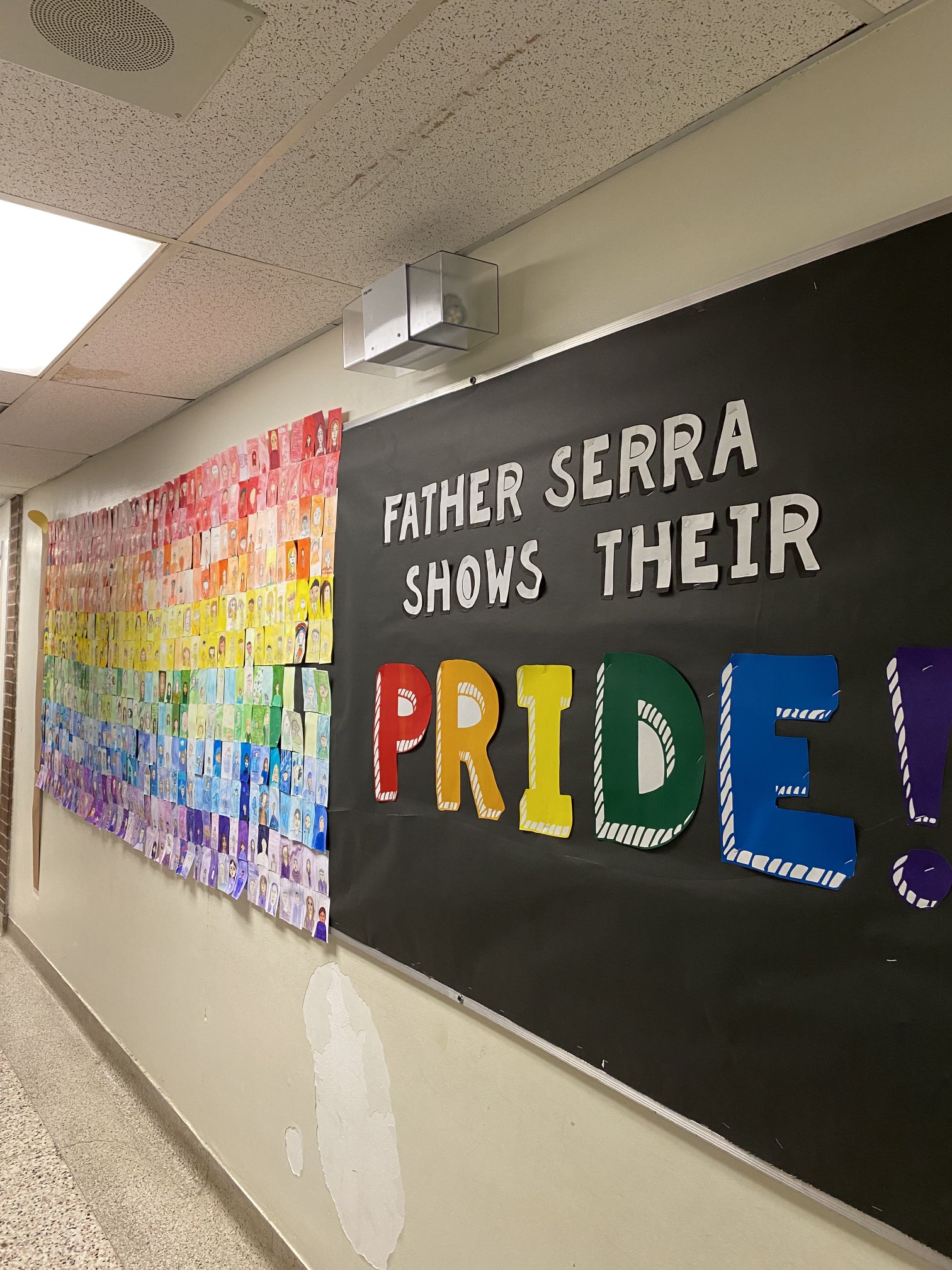 A picture showing the hallway of Father Serra with 'Father Serra Shows Their Pride' written on the wall.