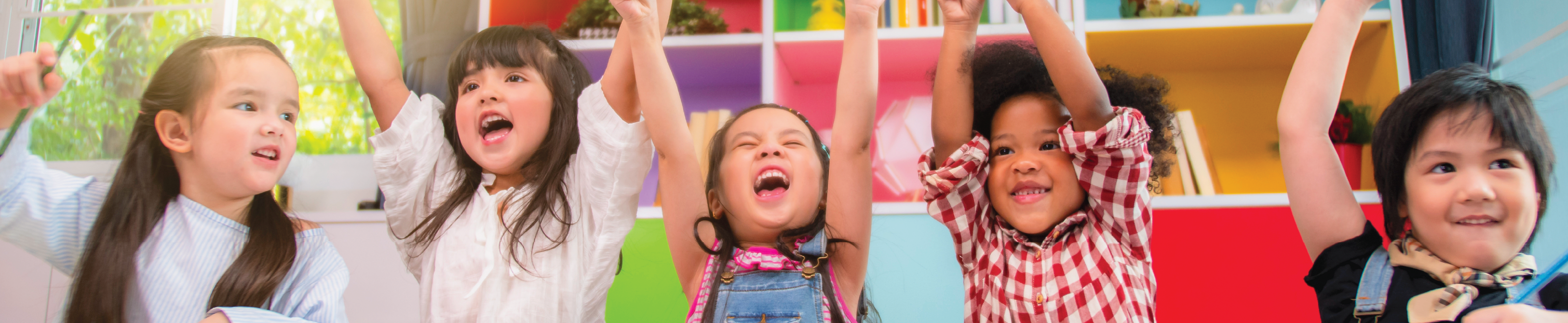 Five cheering students in a classroom