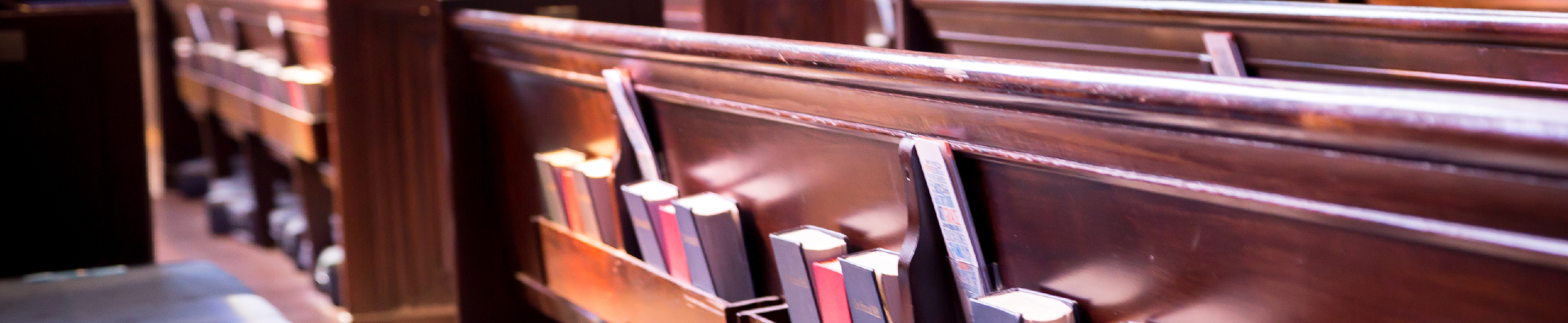 Church pew with worship missals