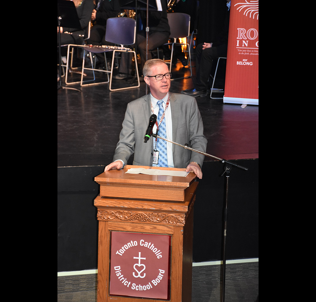 A person speaking at a podium at the we Belong Launch Celebration