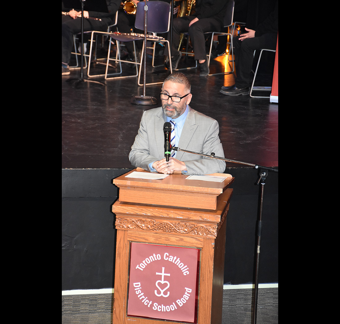 A person speaking at a podium at the we Belong Launch Celebration