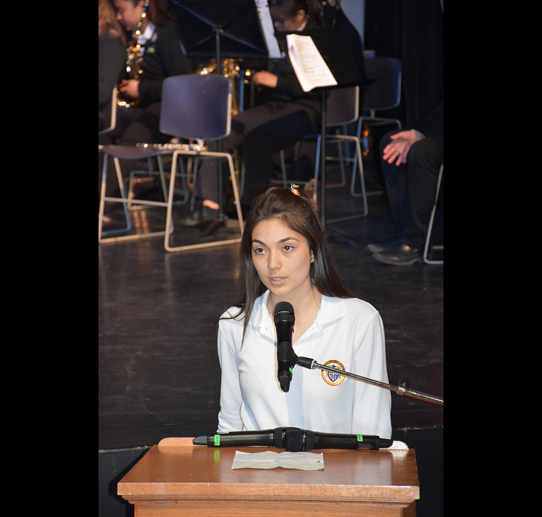 A student speaking at a podium at the we Belong Launch Celebration