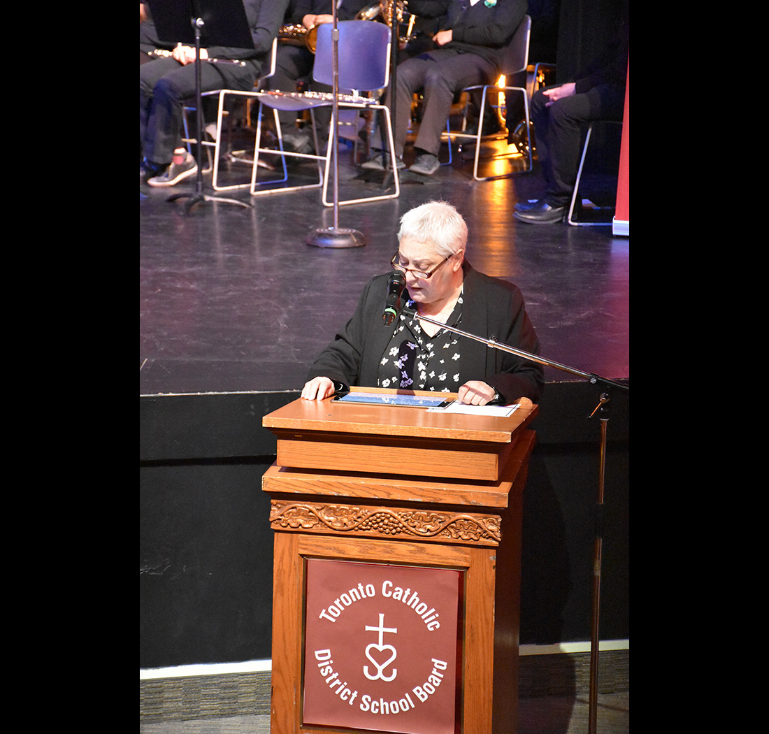 A person speaking at a podium at the we Belong Launch Celebration