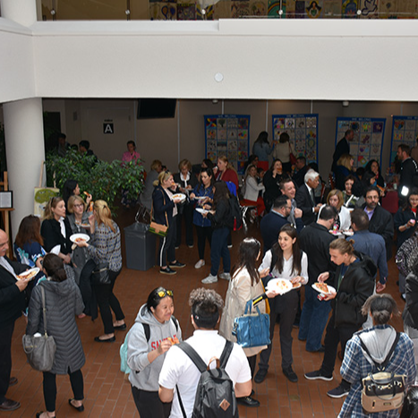 A gathering of people with refreshments at the we Belong Celebration Launch