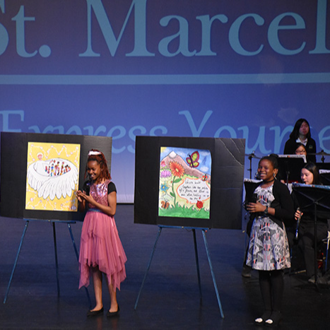 Two students presenting on stage at the we Belong Launch Celebration