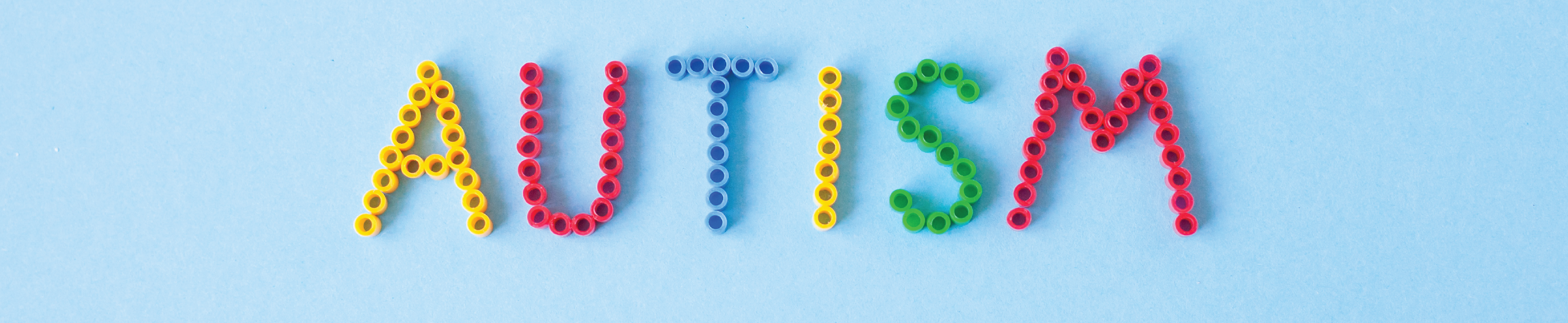 The word “autism” spelled out with beads.