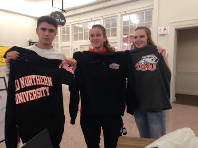 picture of foreign exchange students holding t-shirts