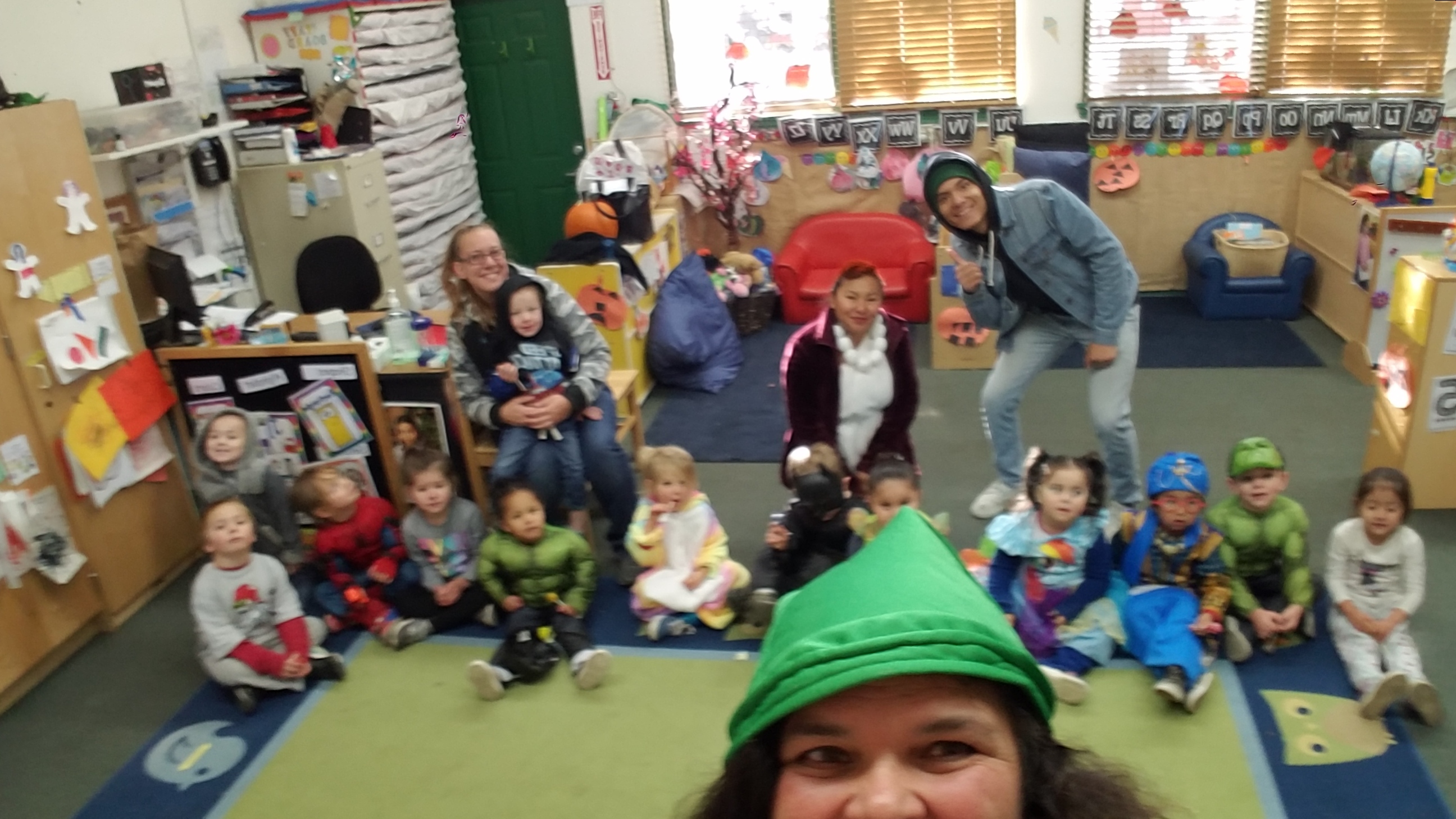 teacher taking a selfie with rest of class in the background