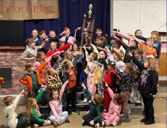 Group photo with confetti on blue background. Students hold trophy. Text reads: "Congratulations Church Hill Elementary School".