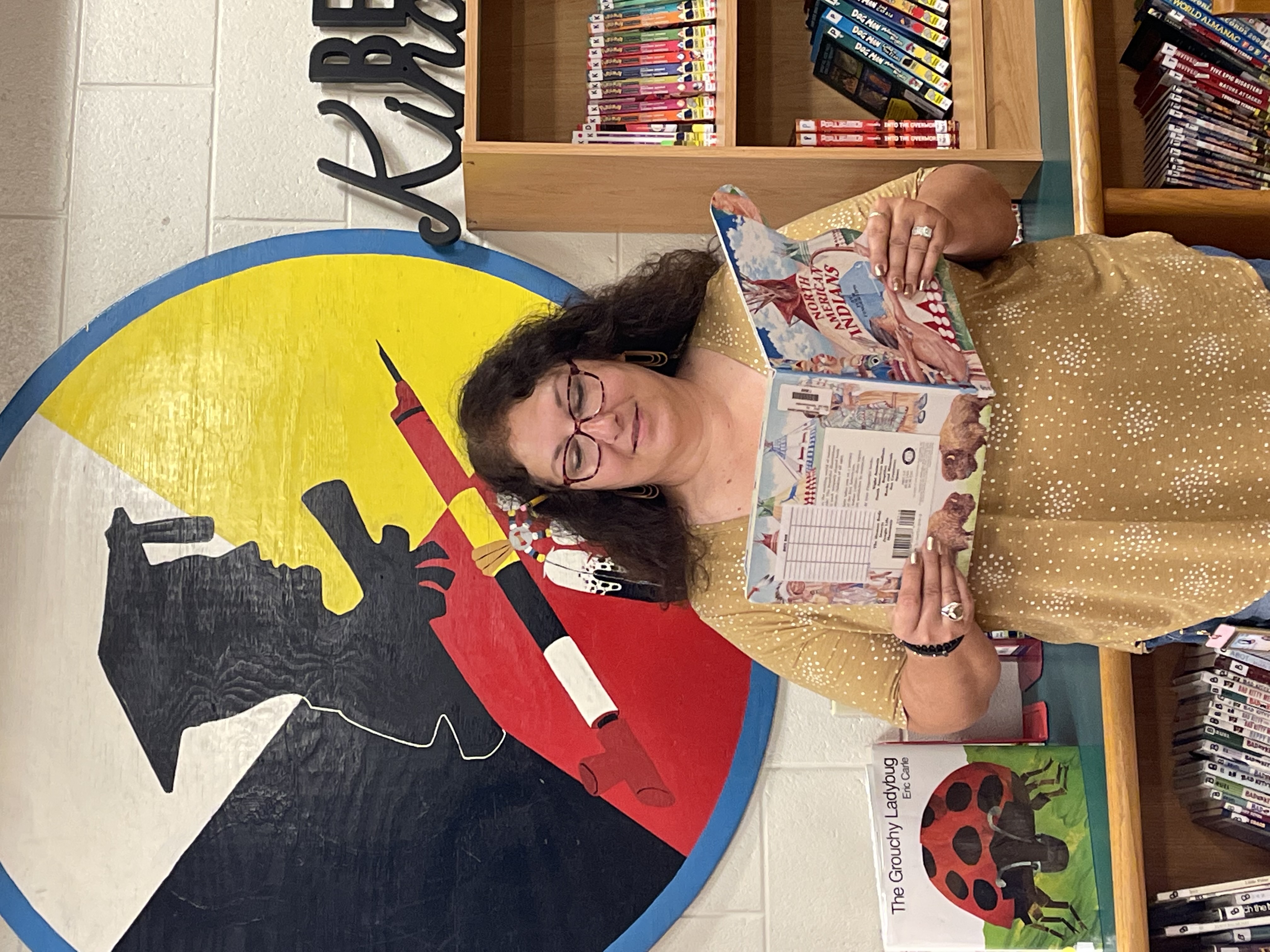 Mrs. Nelson reads to children from the school's Native American book section