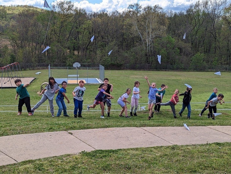 Students throw paper airplanes