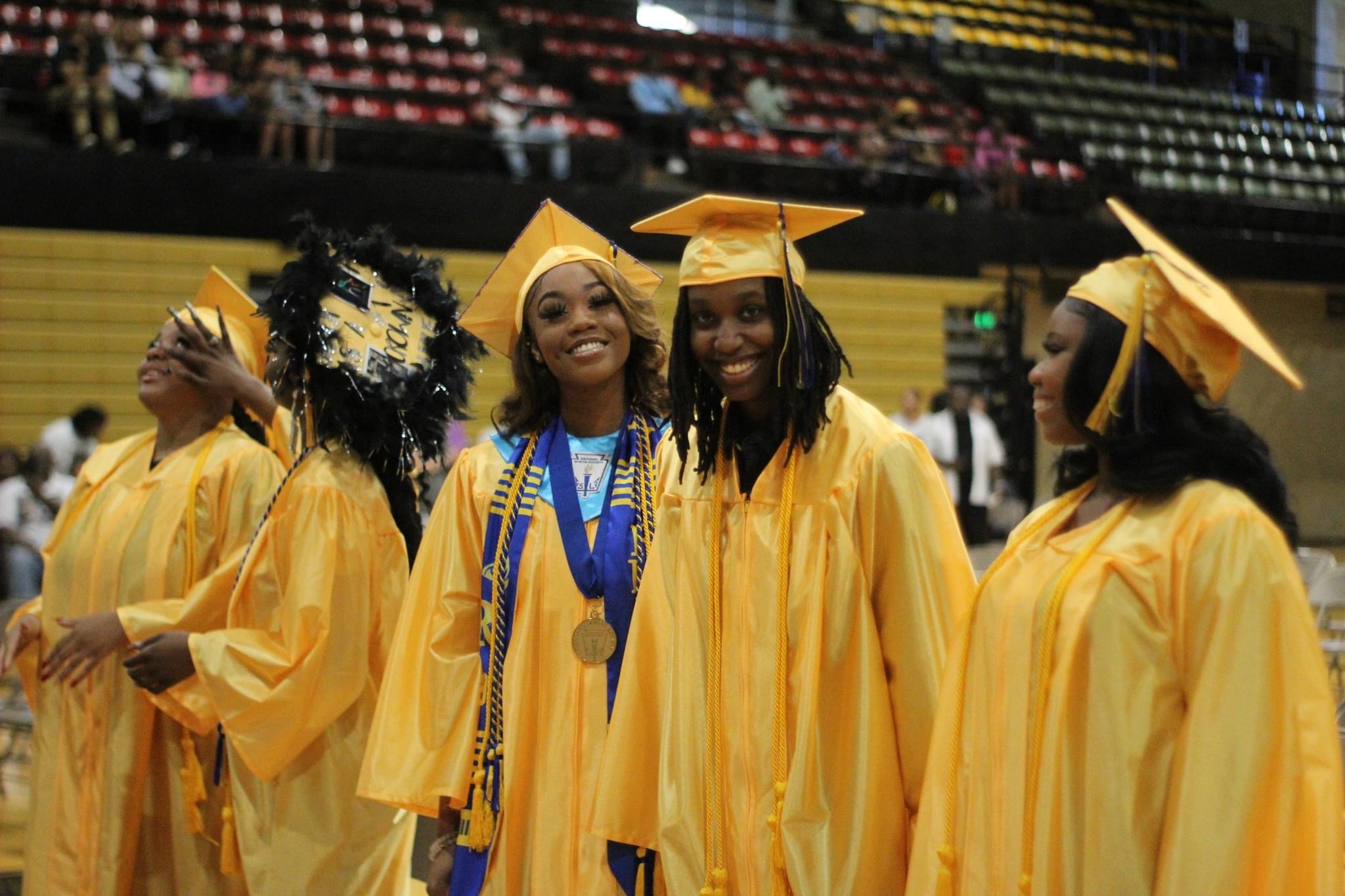 Scholars at graduation in cap and gown