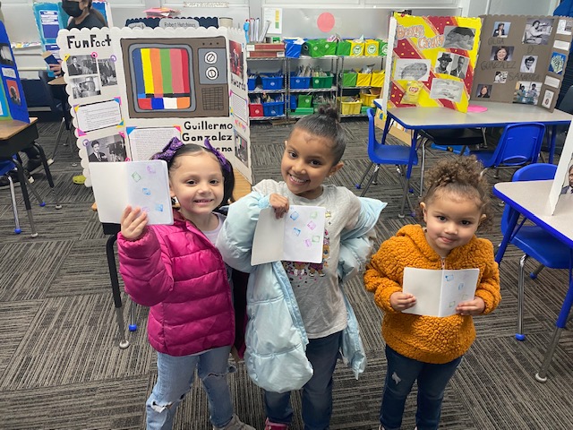 three little girls holding up passports with stamps