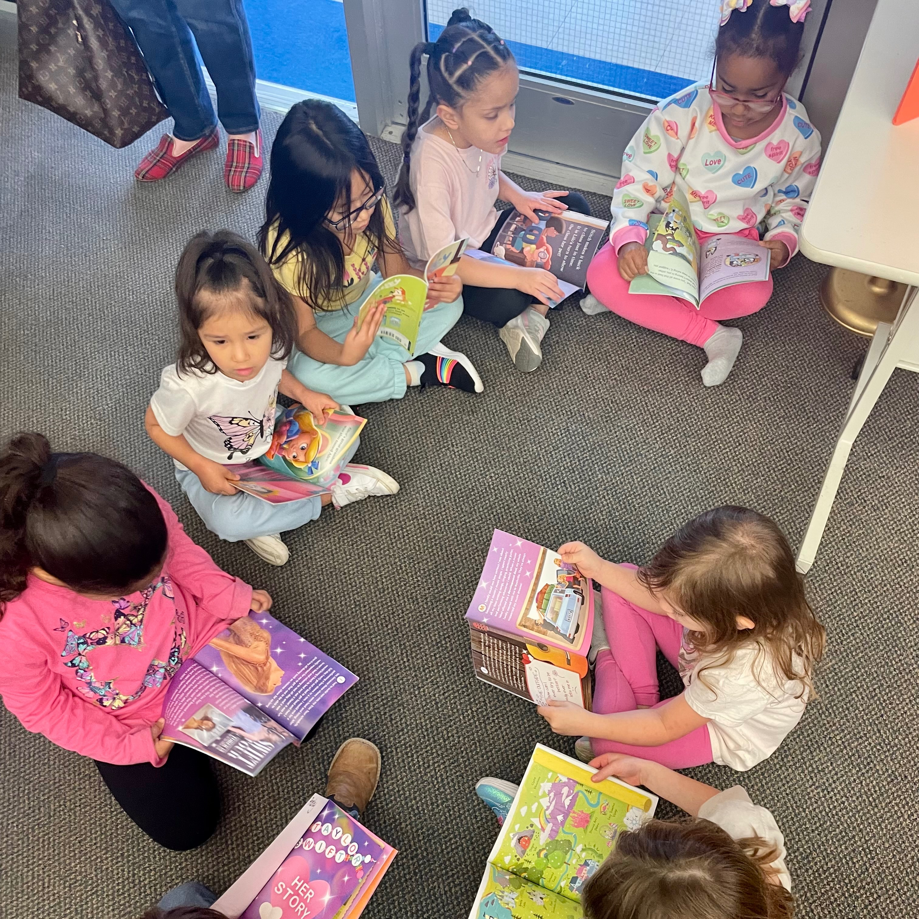 Pre-Kindergarten students read books