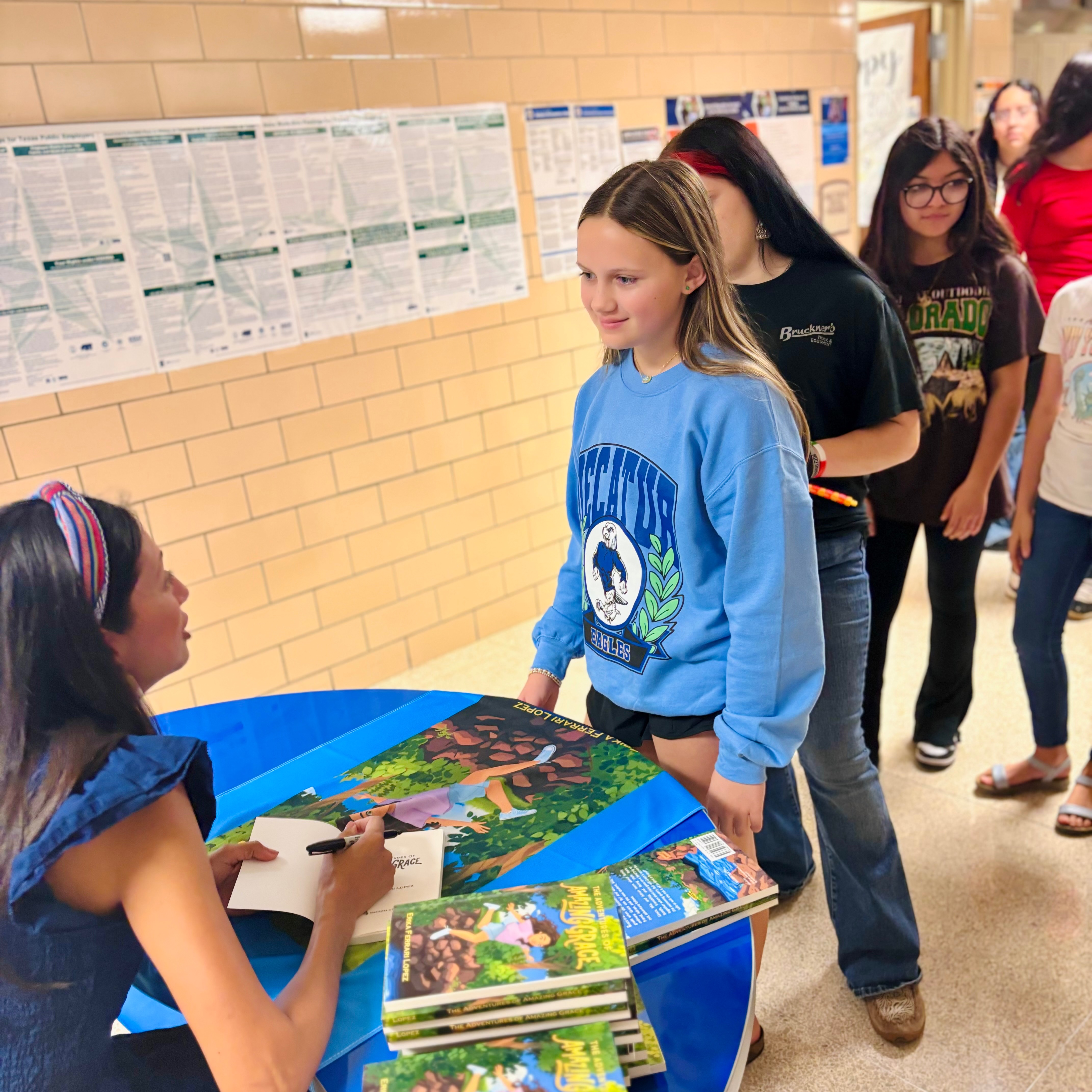 Elementary and middle school students get a published author to sign books during Dyslexia Day