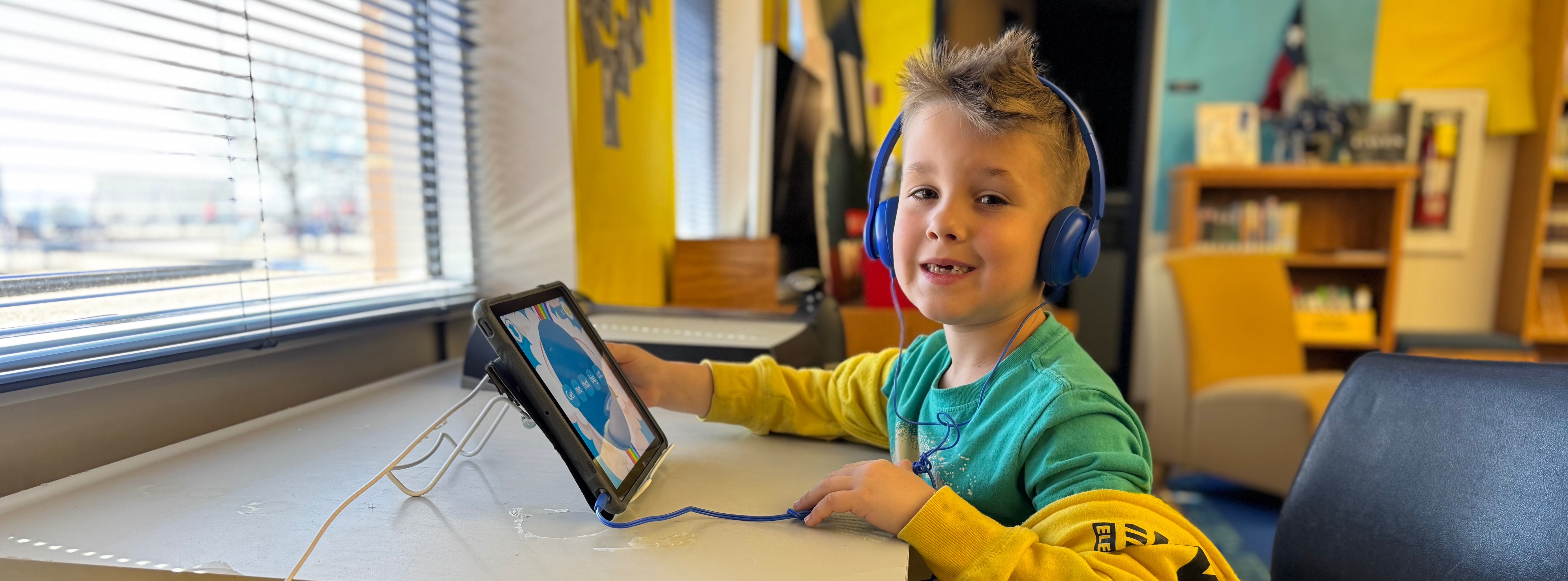 Carson Elementary Student using laptop inside the library