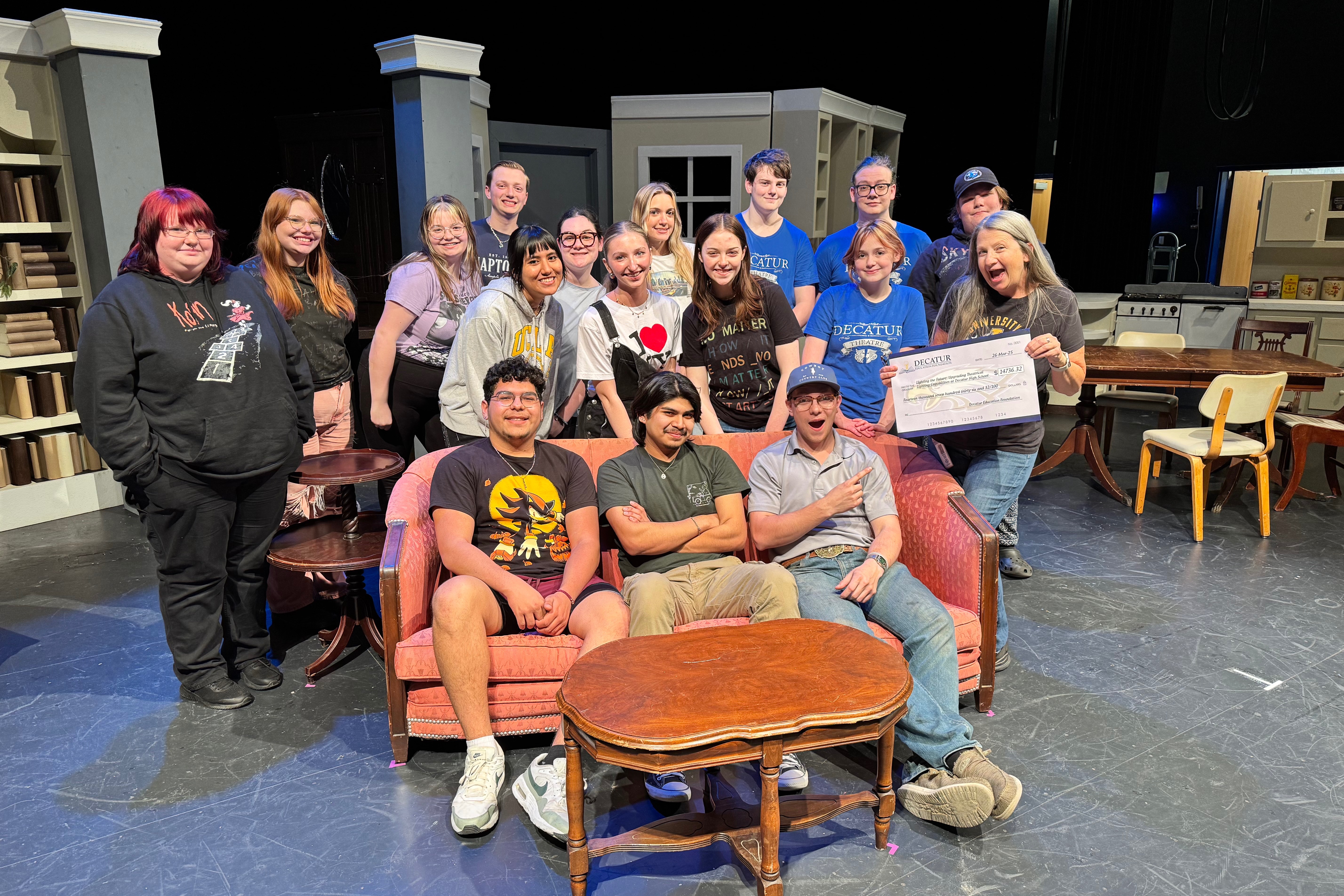 Decatur High School theatre students pose for a photo on the rehearsal stage after reaching a $14,000 grant for a new light board