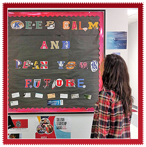 Student stands in front of a sign made out of college logos that reads keep calm and plan your future