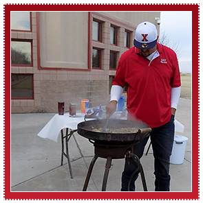 Man cooking at a grill outside