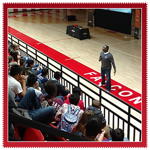 Teacher talking to students in the bleachers 