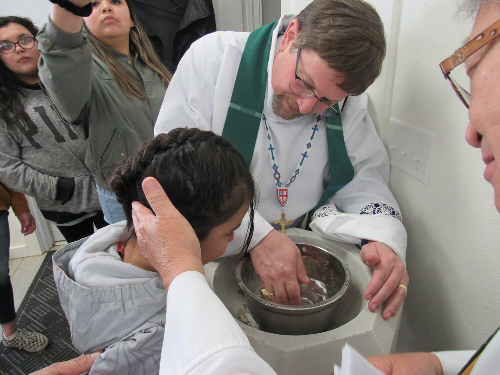 A kid getting baptized