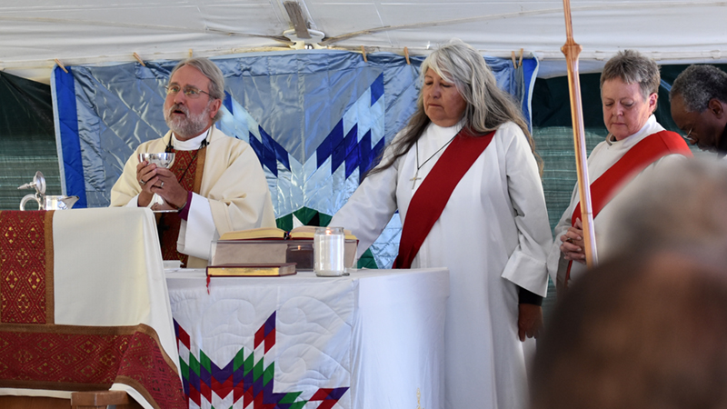 South Dakota Bishop John Tarrant celebrates the Eucharist during the diaconate ordination of the Rev. Twilla Two Bulls, standing next to Tarrant, on June 24. Photo: David Paulsen/Episcopal News Service