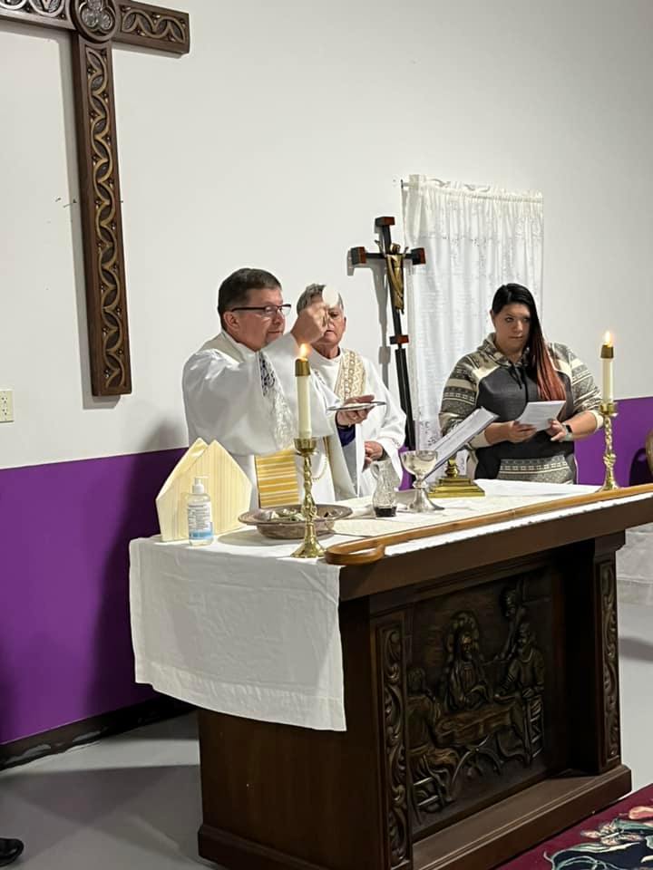 Priest celebrating the eucharist at the altar