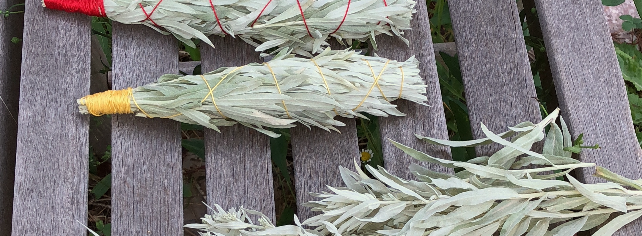 Bundles of sage lying on planks of wood