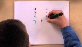 Kid making equations in a white paper