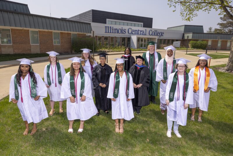 graduates standing in garb