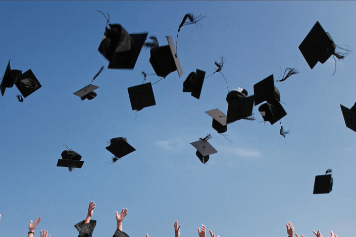 graduates standing in garb