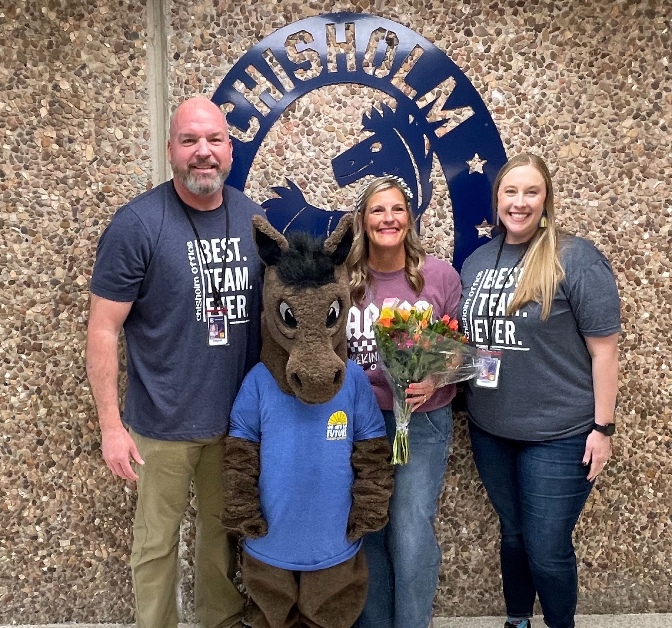 Leigh Cobb being recognized by Mr. Higdon and Mrs. Cluck at Charge Up for being the Teacher of the Year