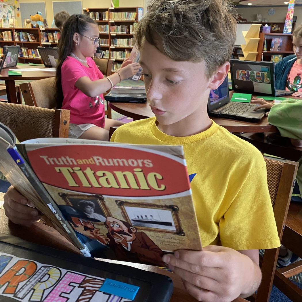 student reading in the library independently