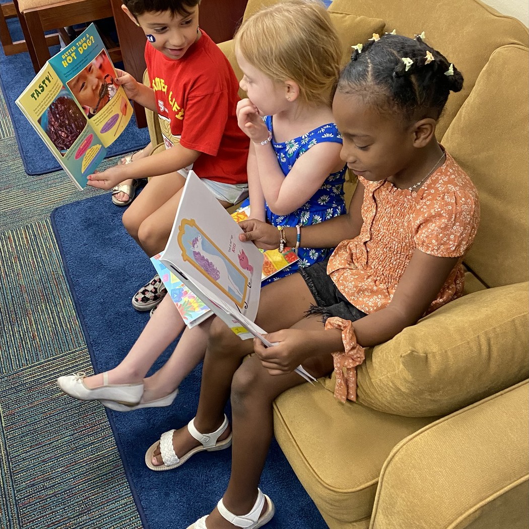 Kids reading on a couch together