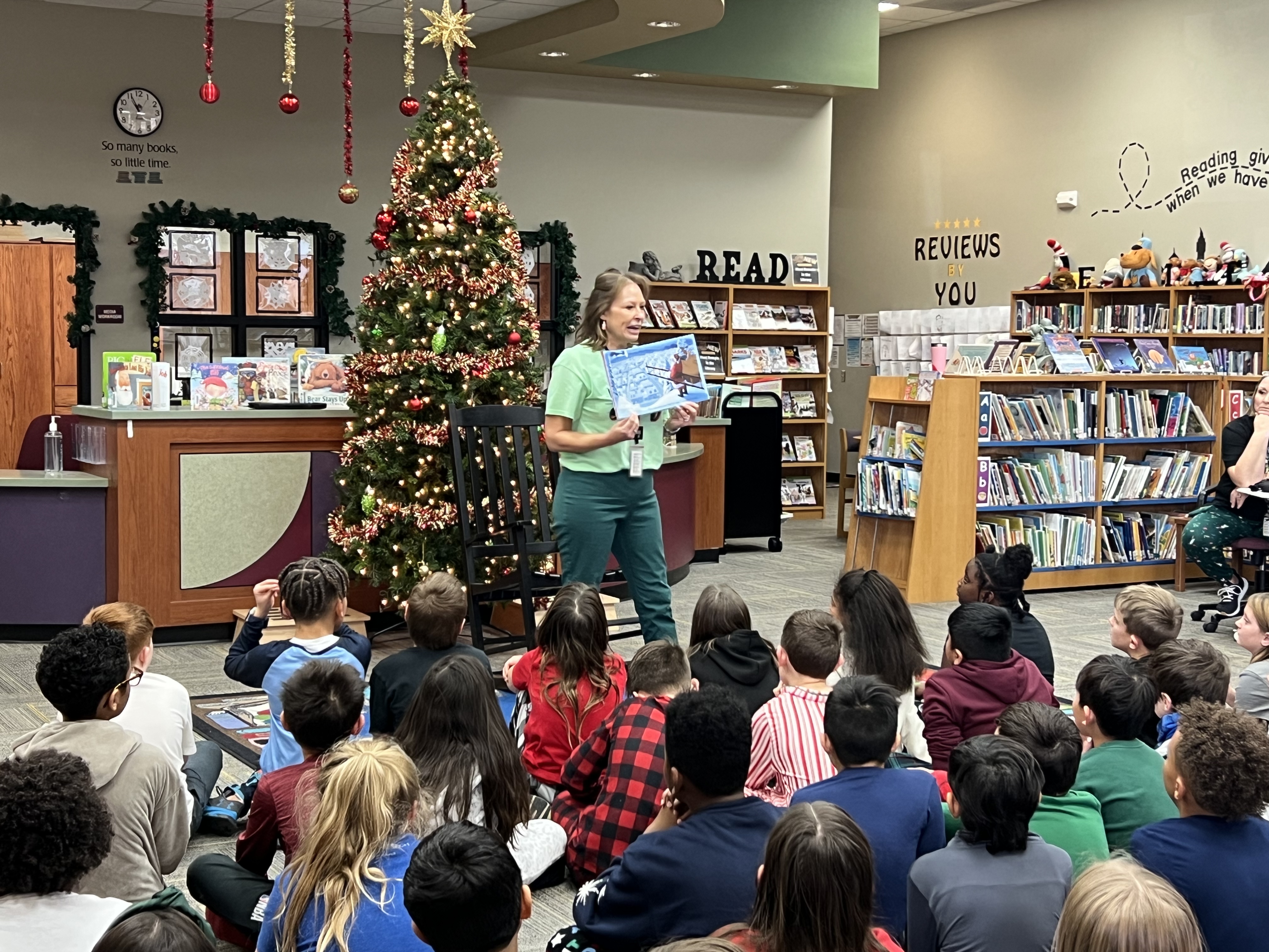 Dr. Grunwald reading to students in library