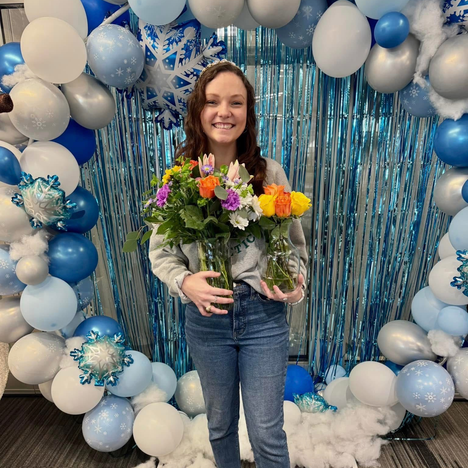 Rookie of the Year Alex Williams holding two vases of flowers