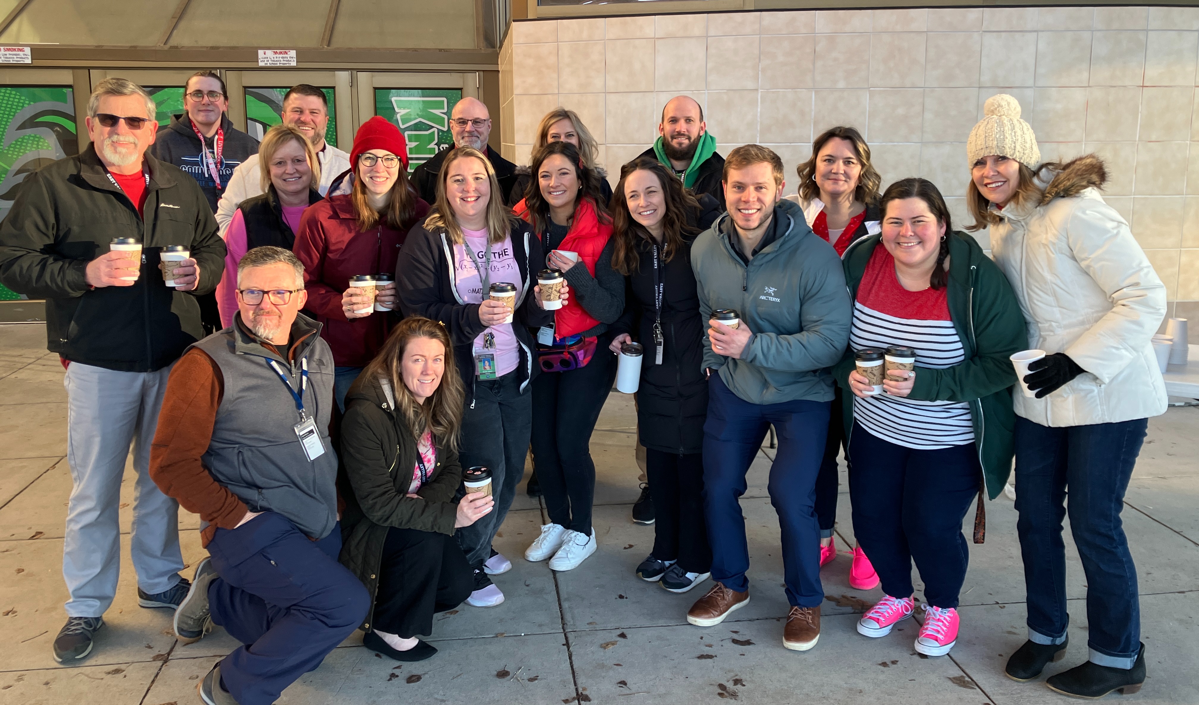 staff gathered to hand out hot cocoa to students