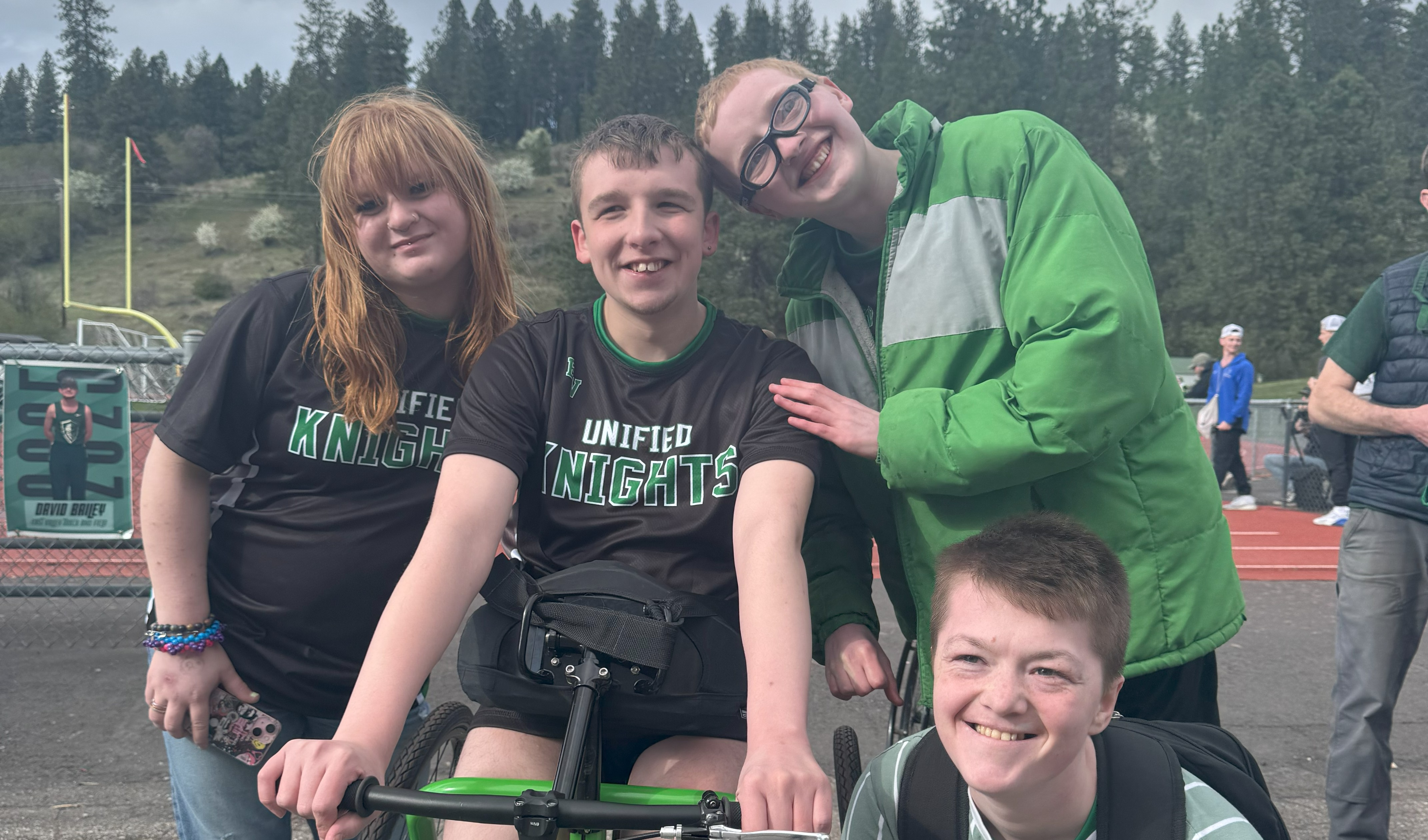 students outside on a black top posing for a picture