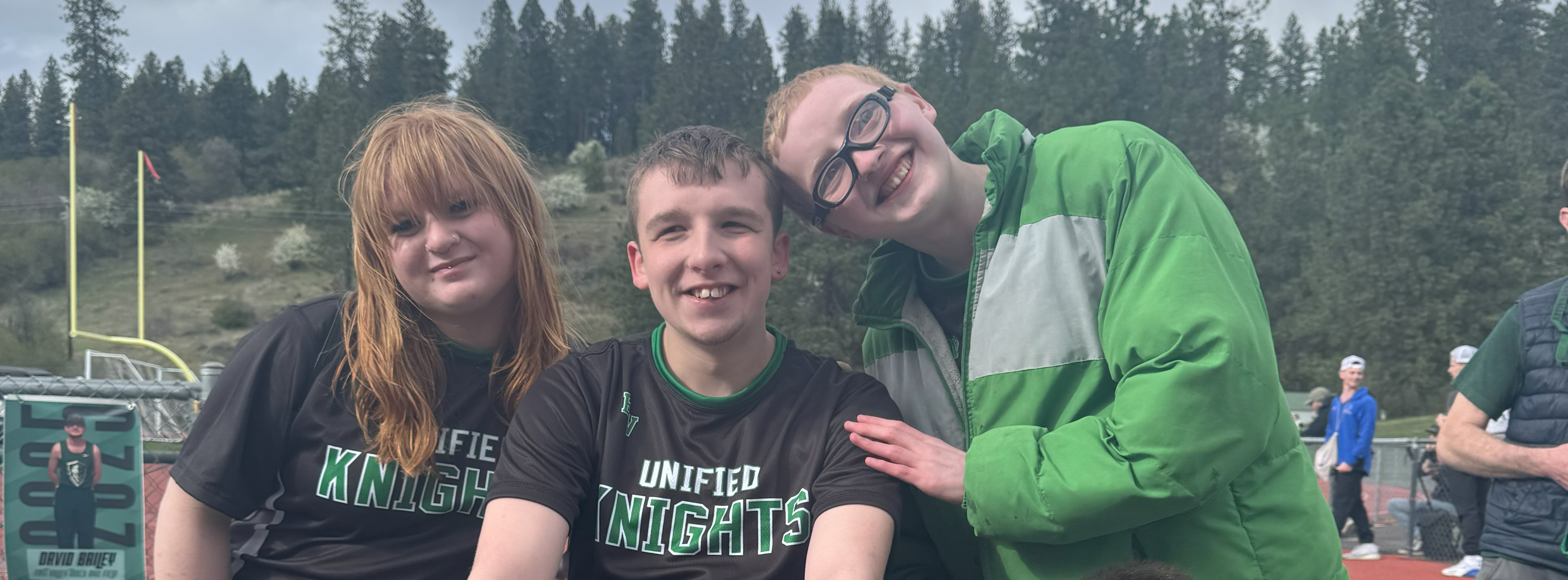 students outside on a black top posing for a picture