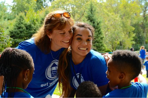 Teacher and Students smiling in a cricle