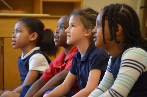 Four students looking up at teacher 