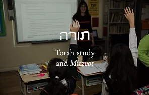 teacher in front and students raising their hands in classroom