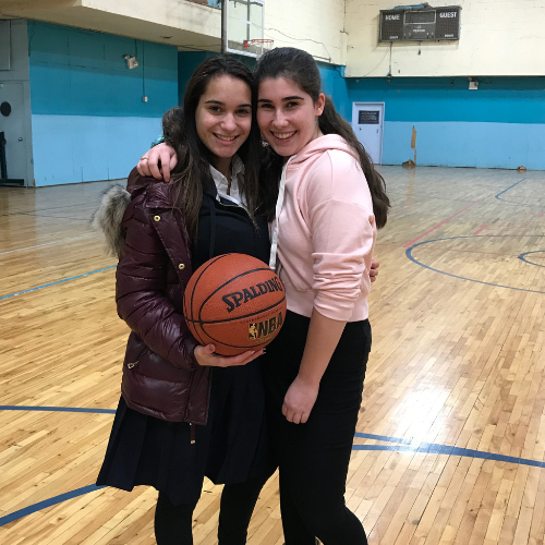 students in a gym holding a basketball