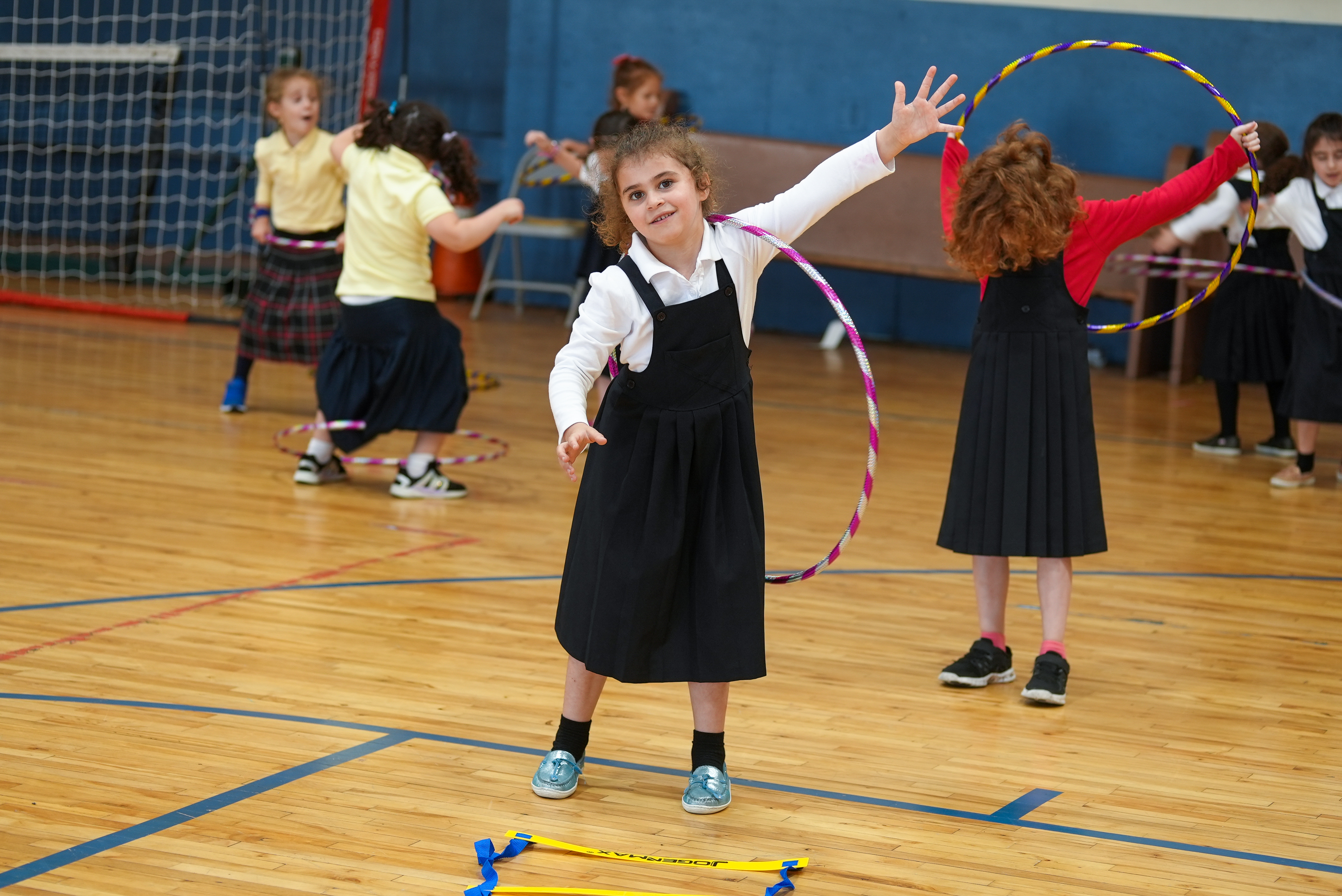 students in a gym holding a basketball