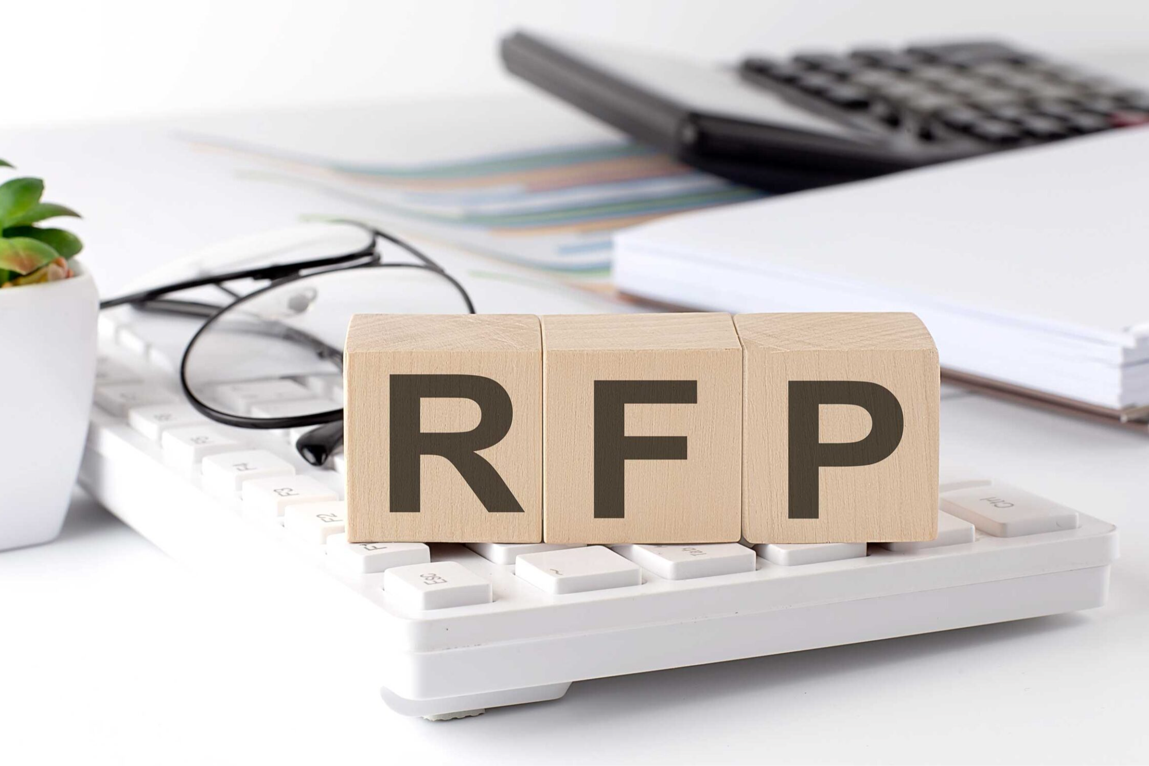 Wooden blocks spelling out RFP in office environment