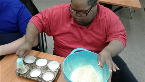 a student making cupcakes