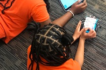 boy and girl work on tablet and car robot