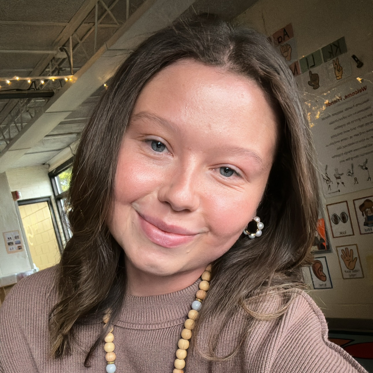 Smiling young woman wearing beige