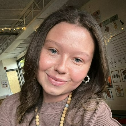 Smiling young woman with fair skin and brown hair