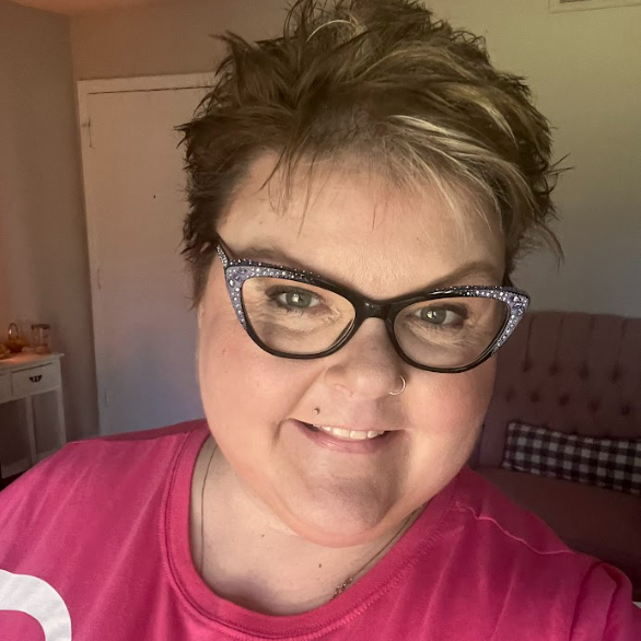 woman with sparkled cats-eye glasses and short spikey hair